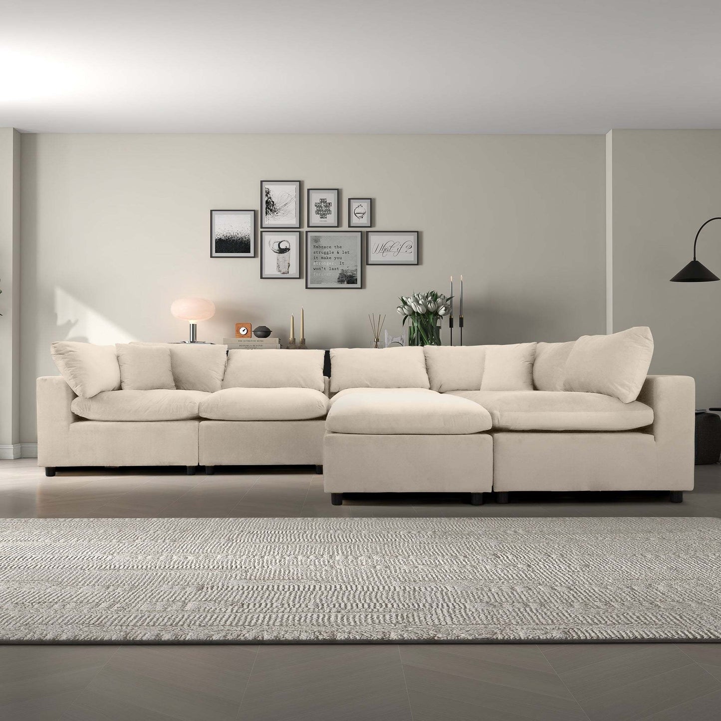 Modern beige sectional sofa in a living room with wall art, neutral decor, and area rug