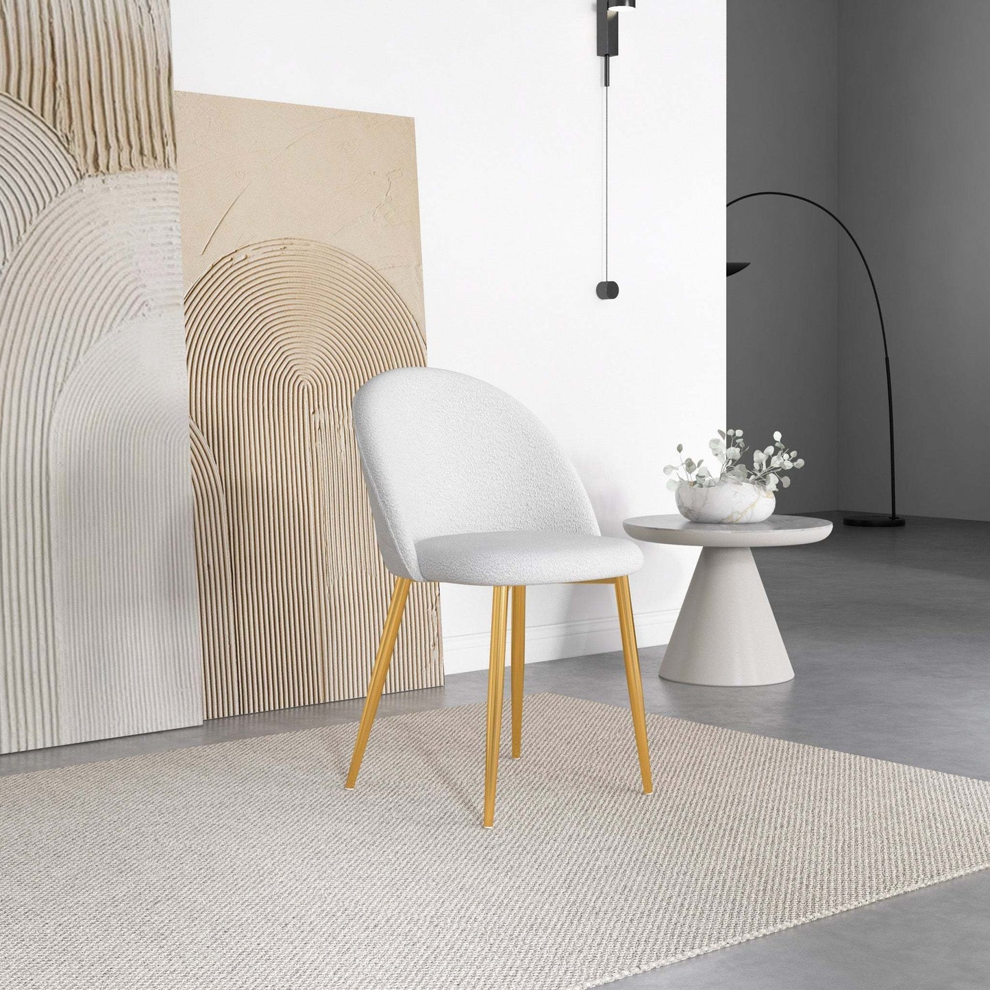 Modern white accent chair with gold legs, minimalist decor, and side table in contemporary living room