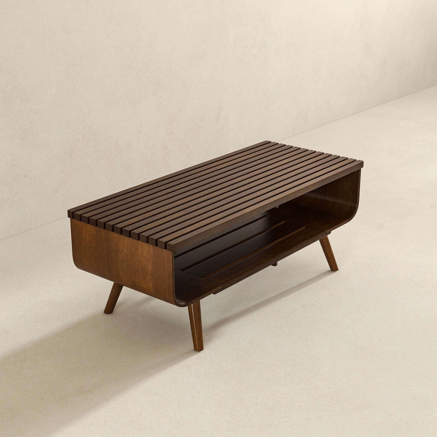 Mid-century modern wood coffee table with slatted top and open shelf on neutral background