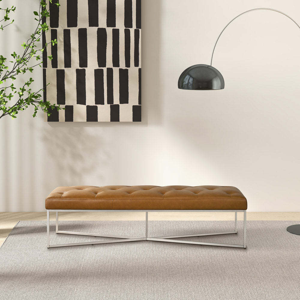 Modern tan upholstered bench with metal legs in a stylish living room, abstract wall art, floor lamp