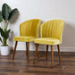 Pair of yellow velvet accent chairs with wooden legs on hardwood floor by FredCo International