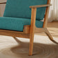 Mid-century modern wooden armchair with teal cushions on beige carpet, FredCo International furniture