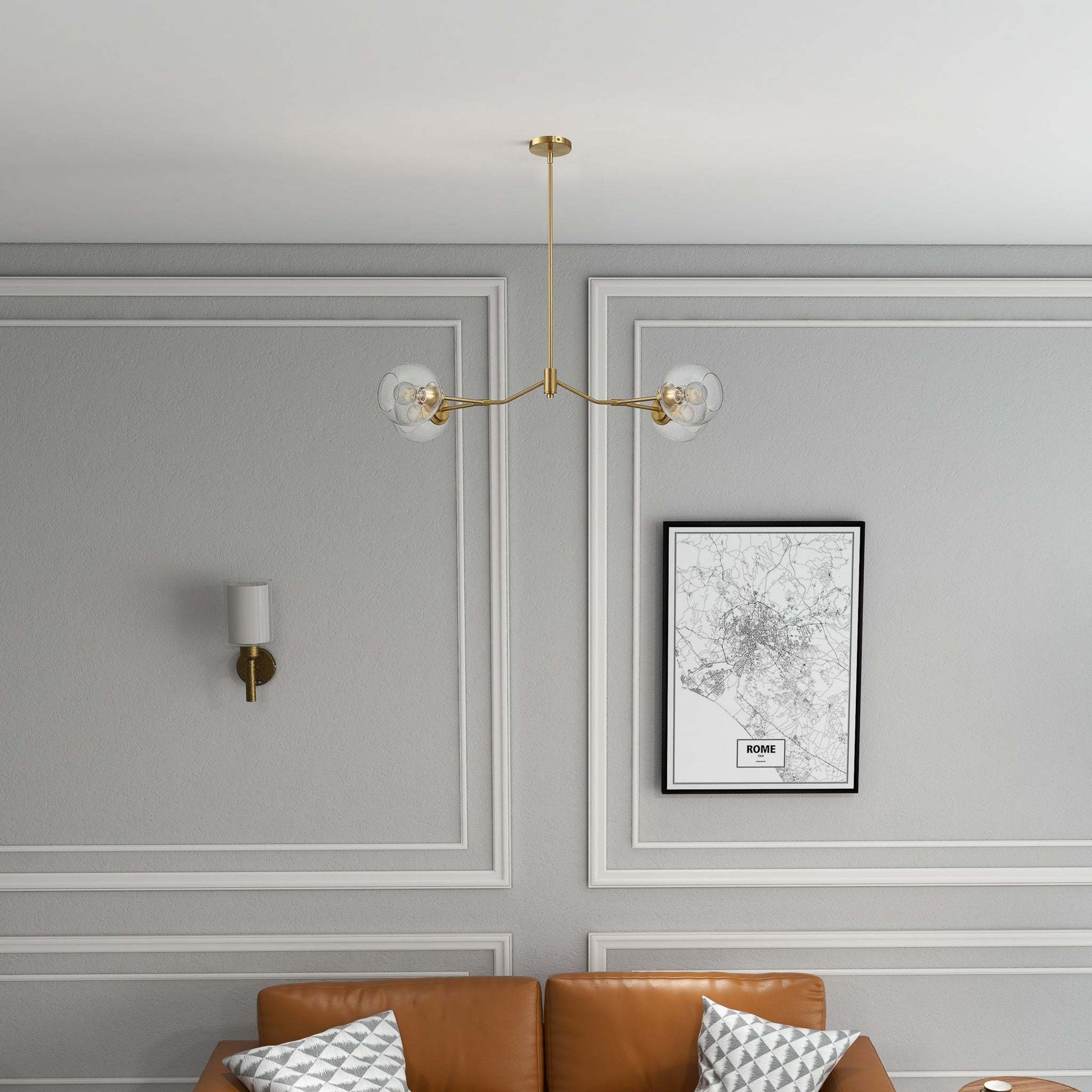 Modern living room with tan sofa, brass chandelier, wall sconce, and Rome map art print