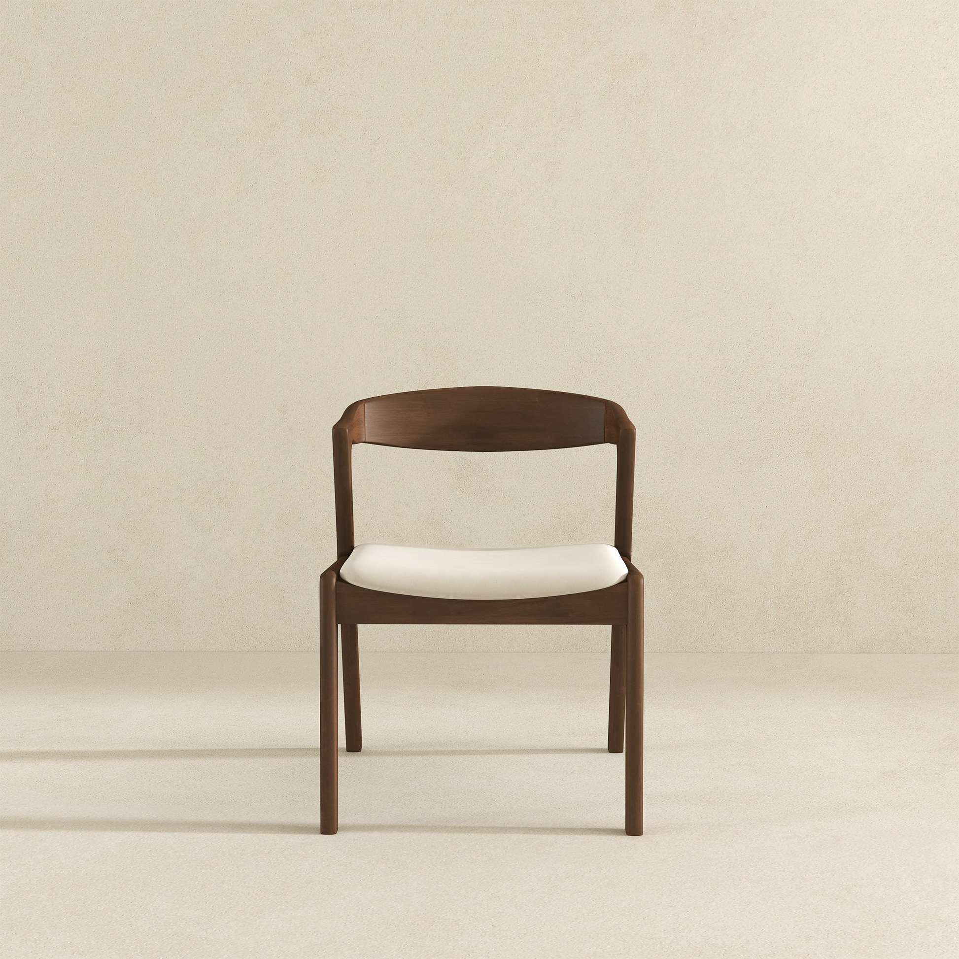 Modern wooden dining chair with white cushion on neutral background, FredCo International furniture