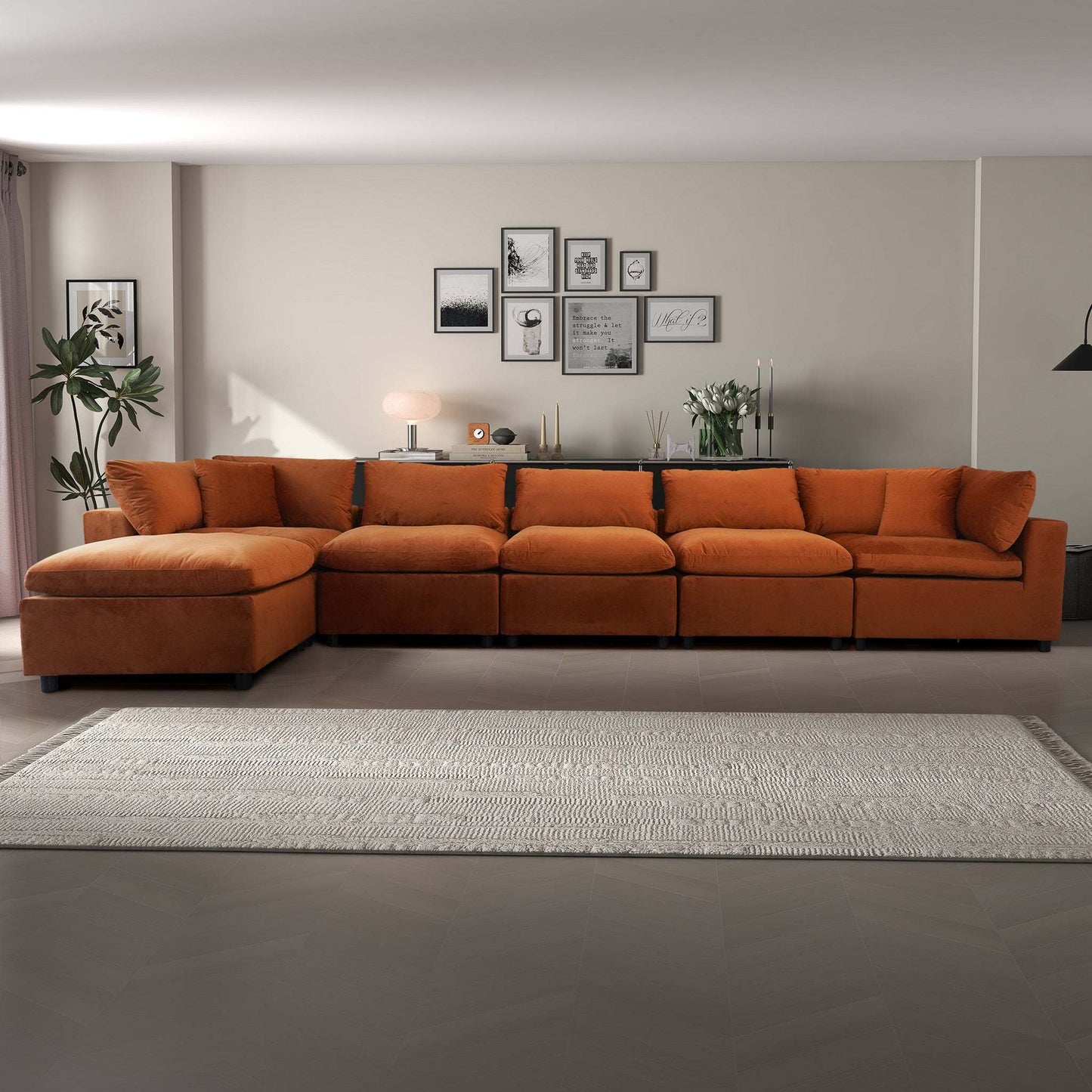 Modern living room with large orange sectional sofa, wall art, and neutral decor from FredCo International