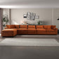 Modern living room with large orange sectional sofa, wall art, and neutral decor from FredCo International