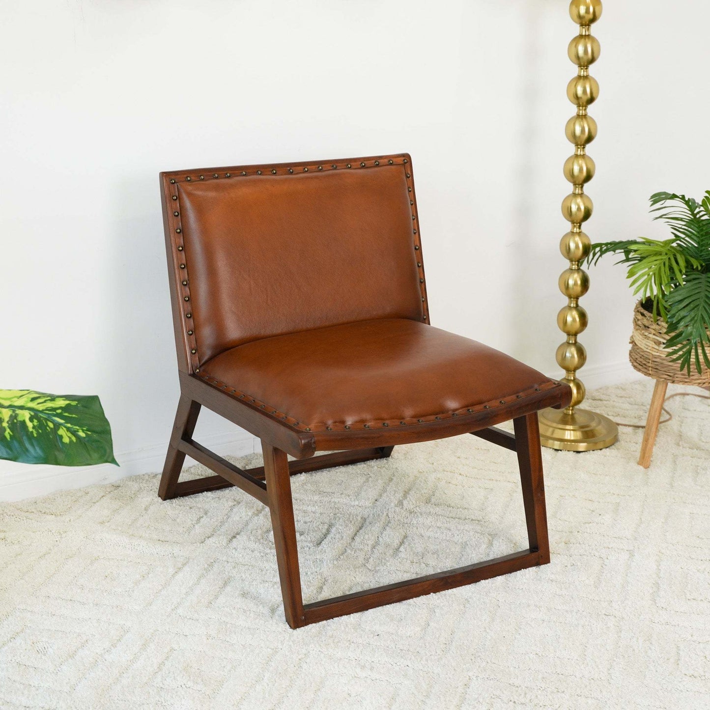 Brown leather accent chair with wooden frame, shown in a modern living room setting.