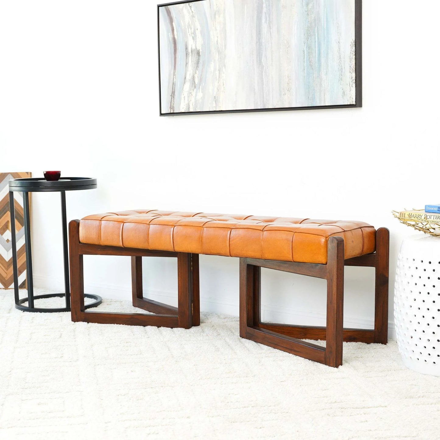 Modern caramel leather bench with wood legs in a stylish living room setting, FredCo International furniture