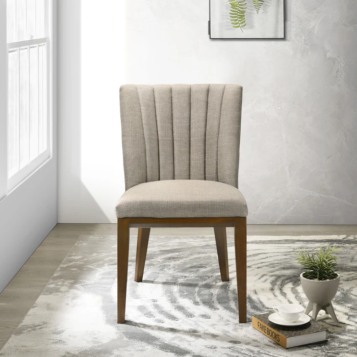 Modern upholstered dining chair with light fabric and wooden legs in a bright home setting