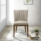 Modern upholstered dining chair with light fabric and wooden legs in a bright home setting