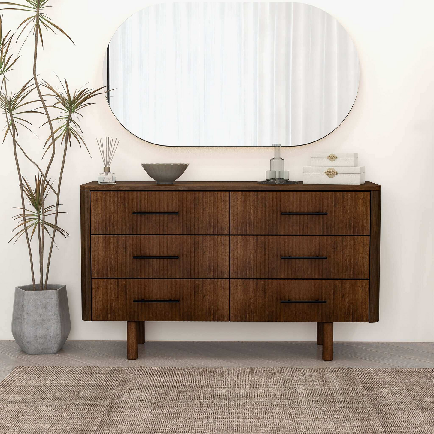 Modern wood dresser with six drawers, large mirror, and minimalist home decor in a bright room.