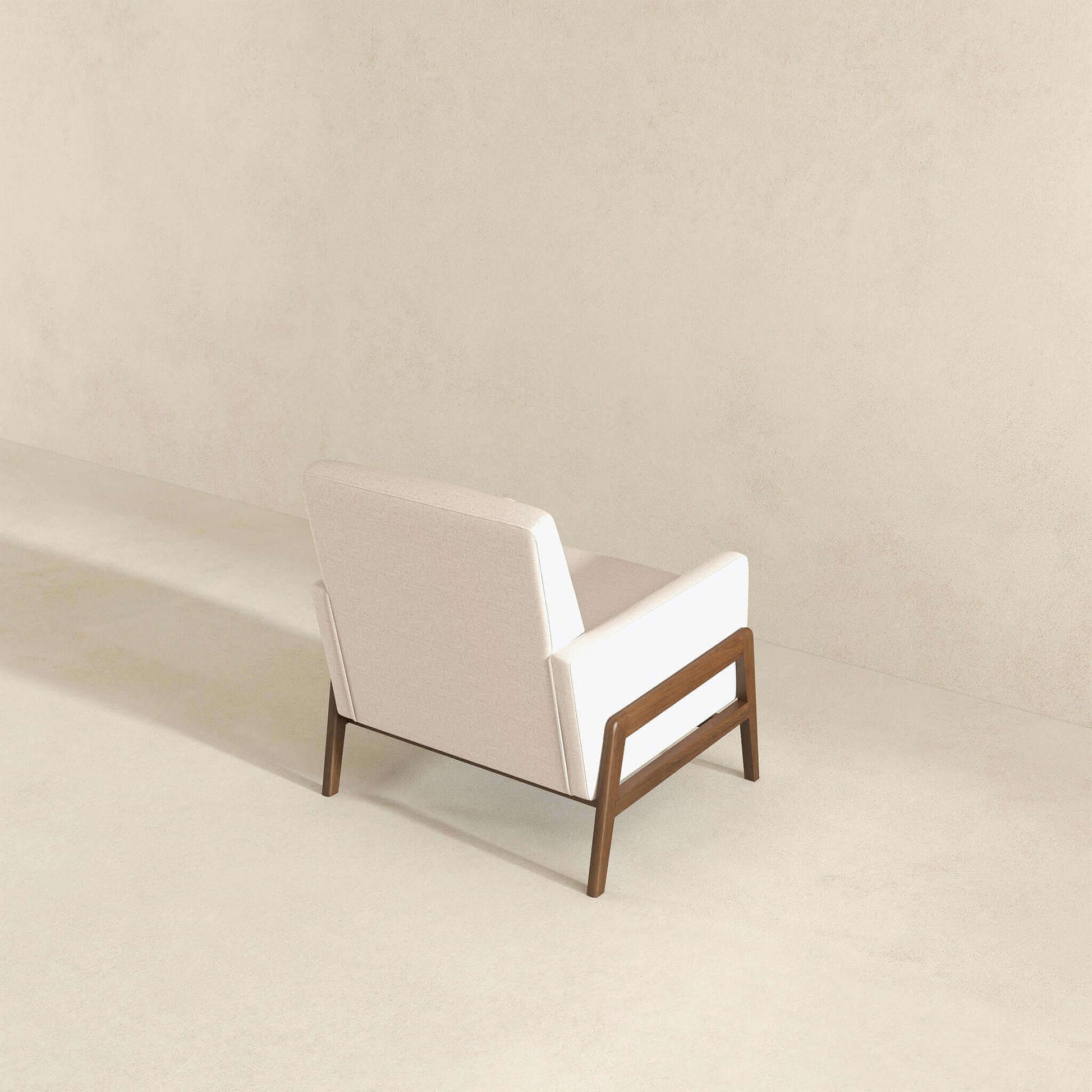 Modern beige armchair with wooden frame in minimalist room, FredCo International furniture