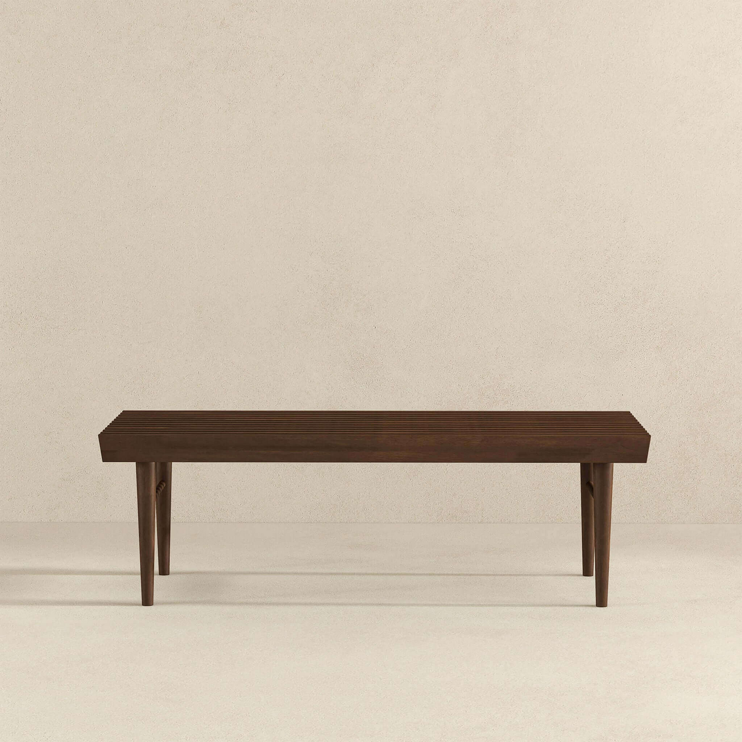 Modern dark wood bench with clean lines on light background, FredCo International furniture