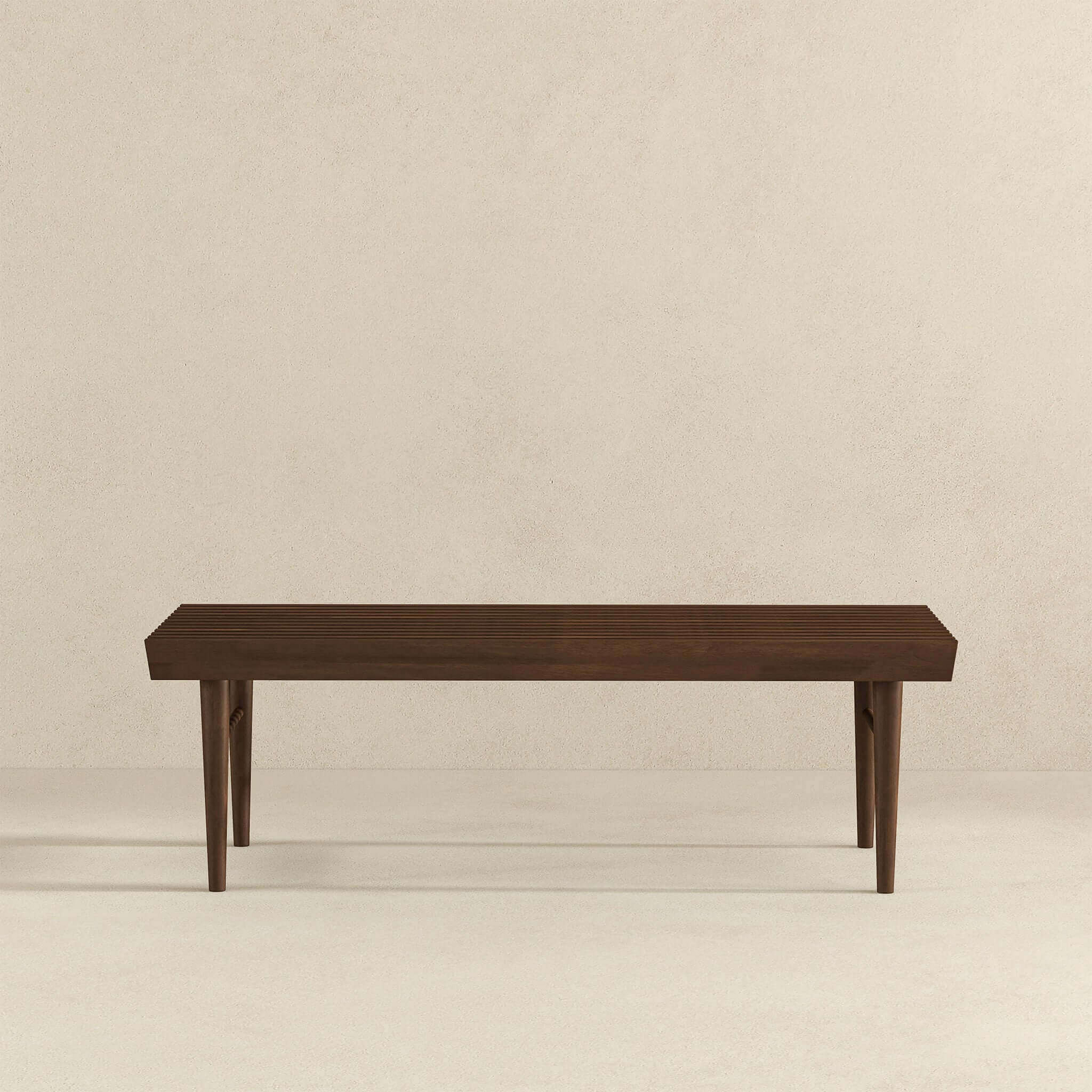 Modern dark wood bench with clean lines on light background, FredCo International furniture
