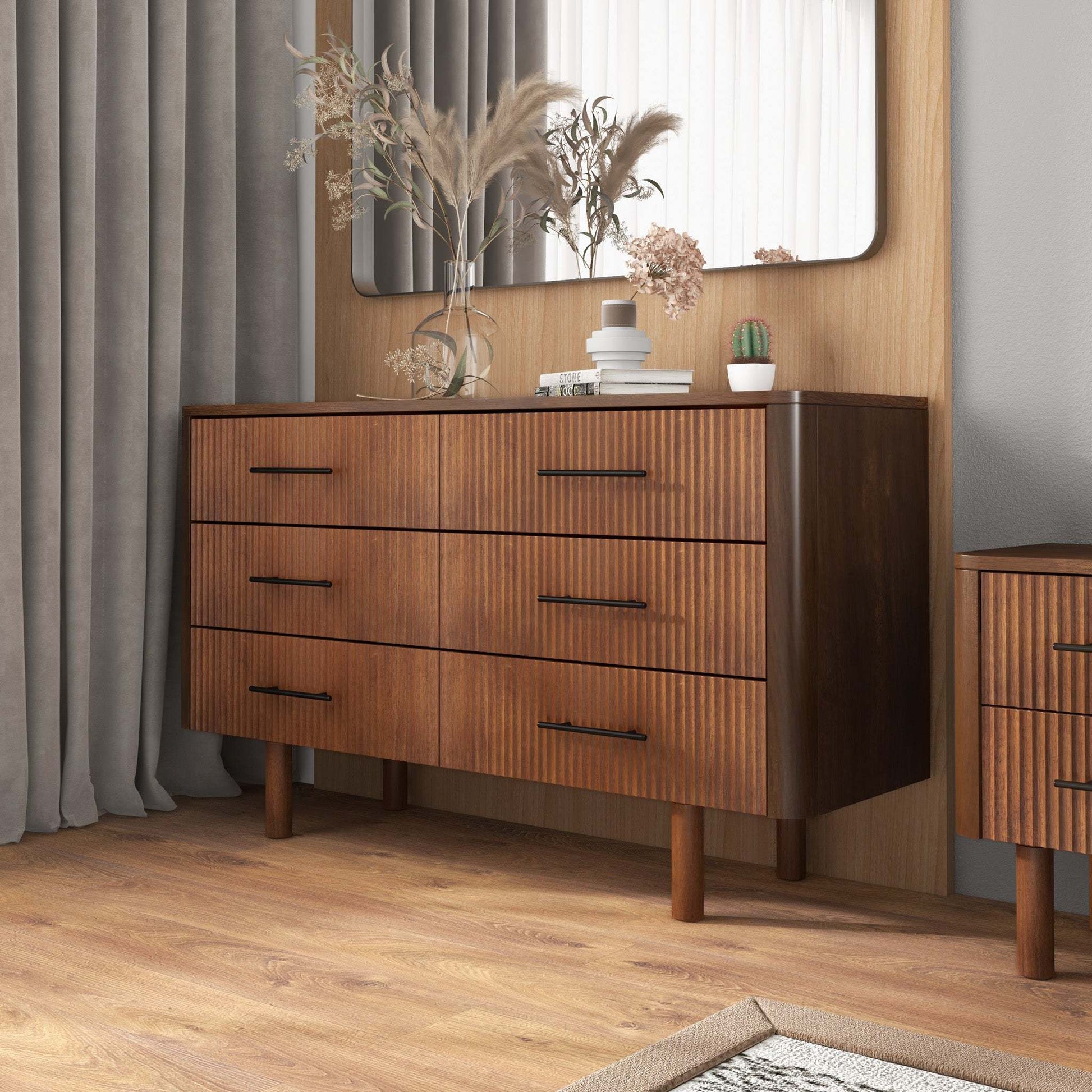 Modern wooden dresser with six drawers, black handles, home decor, and plants, FredCo furniture