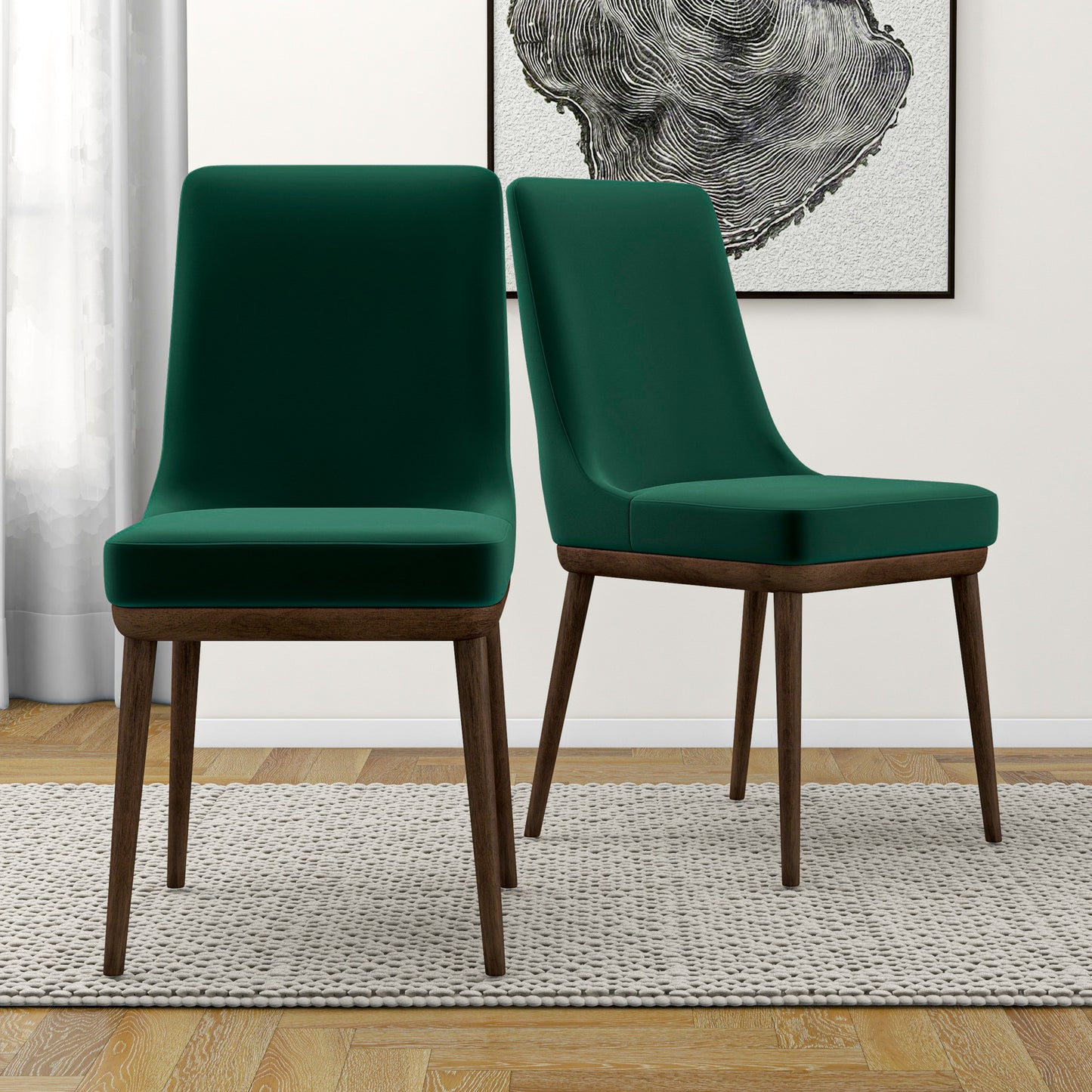 Modern green velvet dining chairs with wooden legs on a light rug in a stylish home interior