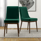 Modern green velvet dining chairs with wooden legs on a light rug in a stylish home interior