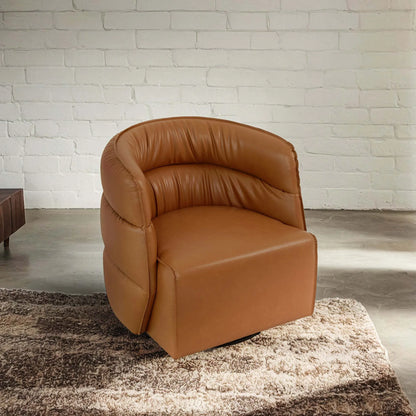 Modern tan leather accent chair on rug in living room, FredCo International furniture