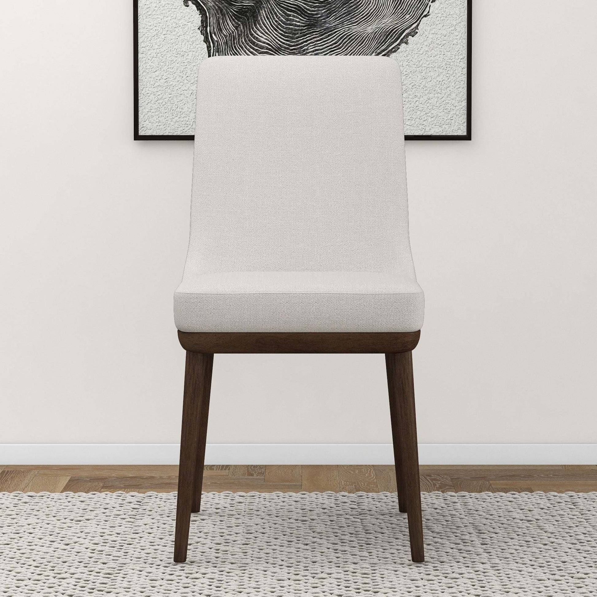 Modern upholstered accent chair with wooden legs on a textured rug, FredCo International furniture