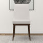 Modern upholstered accent chair with wooden legs on a textured rug, FredCo International furniture