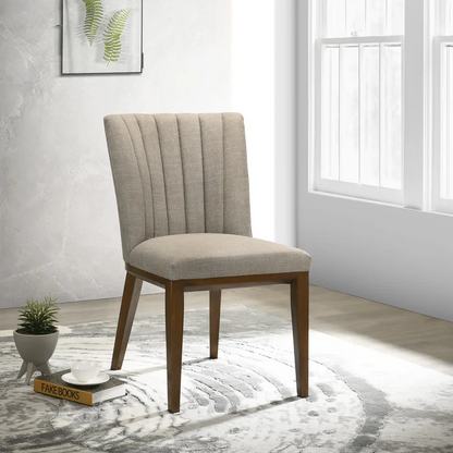 Modern beige upholstered dining chair with wood legs in bright home interior, FredCo furniture