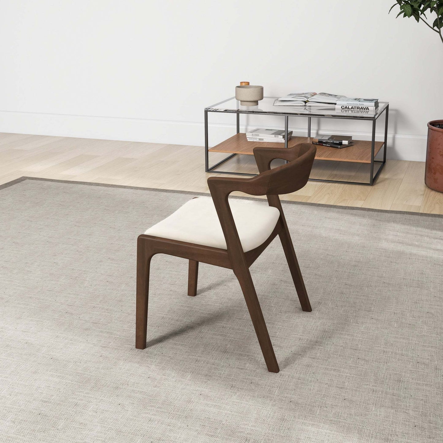 Modern wood accent chair with white cushion on rug in minimalist living room