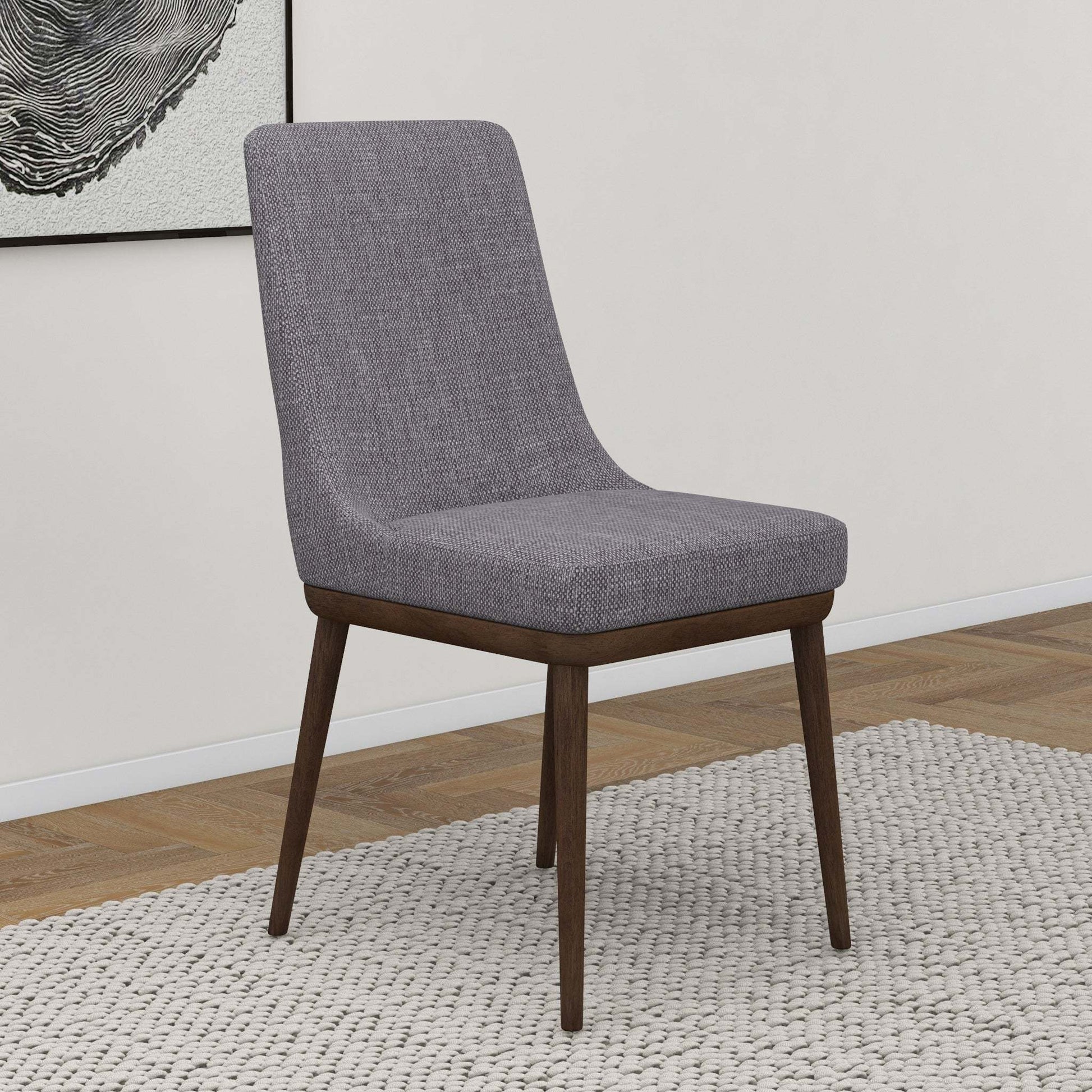 Modern grey fabric dining chair with wooden legs on textured rug, FredCo International furniture