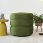 Green velvet ottoman with modern yellow side table in a stylish living room at FredCo International