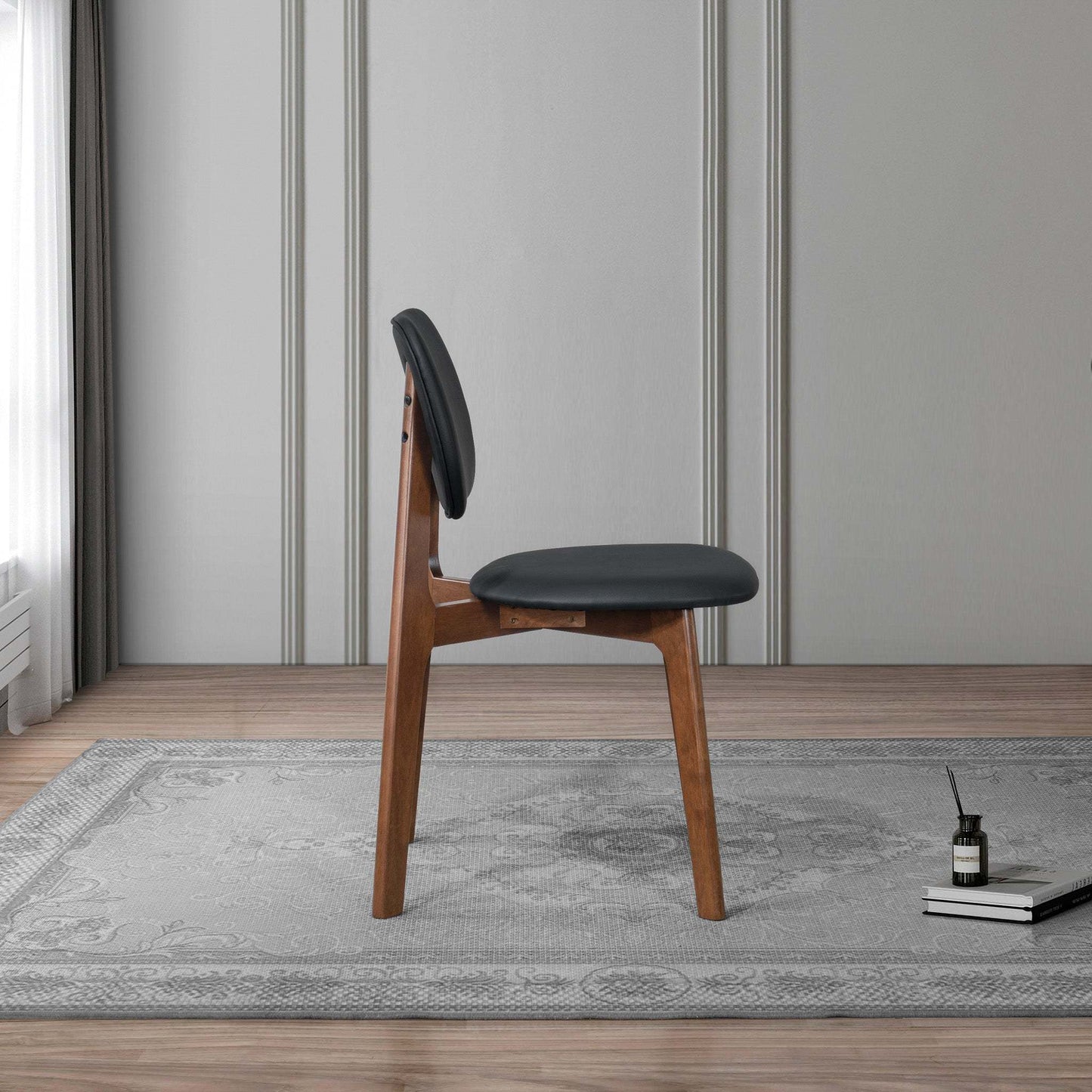 Modern wood chair with black cushion on rug in stylish living room, FredCo International furniture