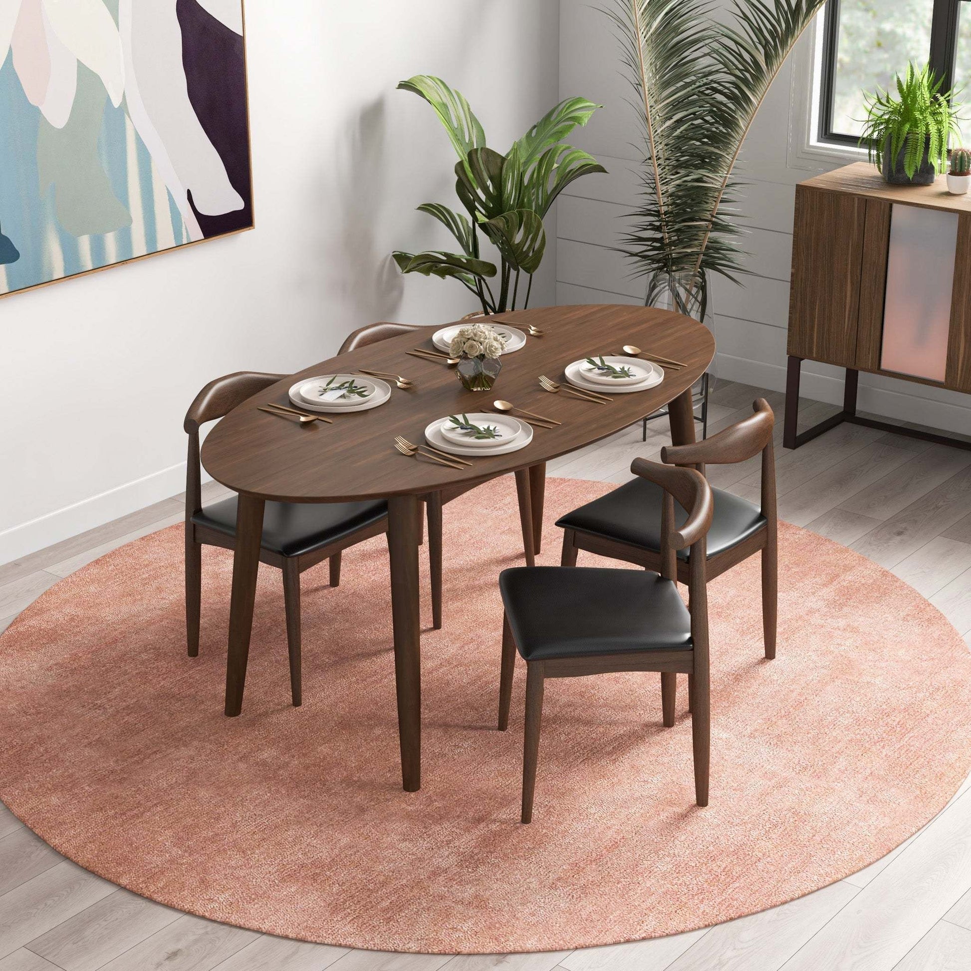 Modern walnut dining table set with four chairs on round pink rug, plants, and wall art