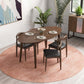 Modern walnut dining table set with four chairs on round pink rug, plants, and wall art