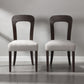 Pair of modern dining chairs with dark wood frames and light upholstered seats