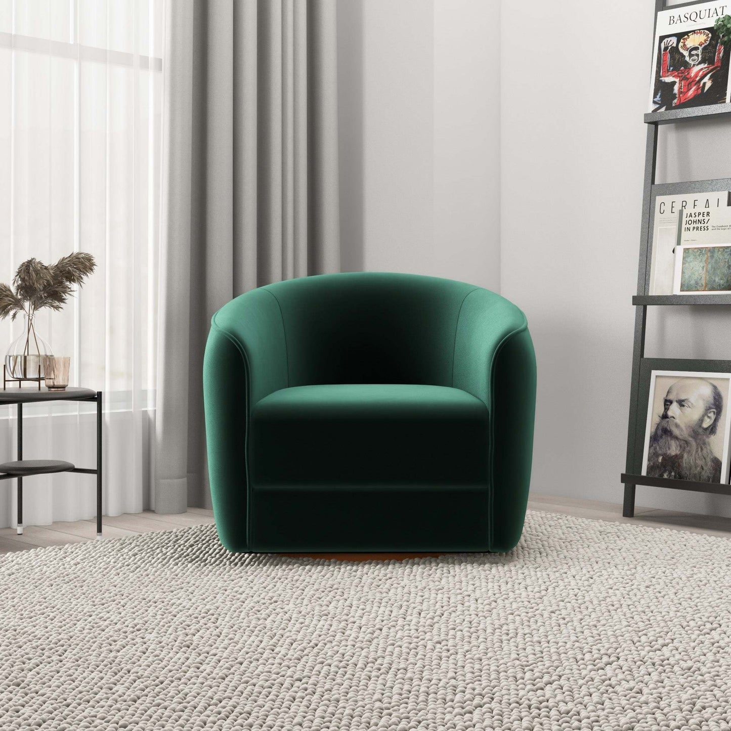 Modern green velvet armchair in a bright living room with a textured rug, bookshelf, and side table.