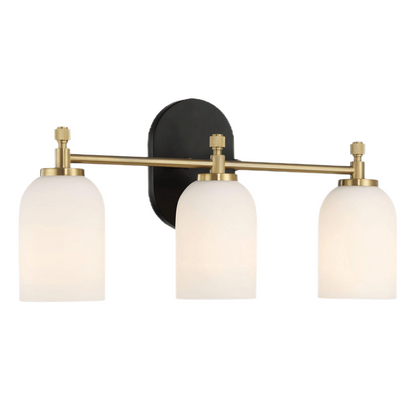 Modern three-light wall sconce with frosted glass shades and brass fixture from FredCo International
