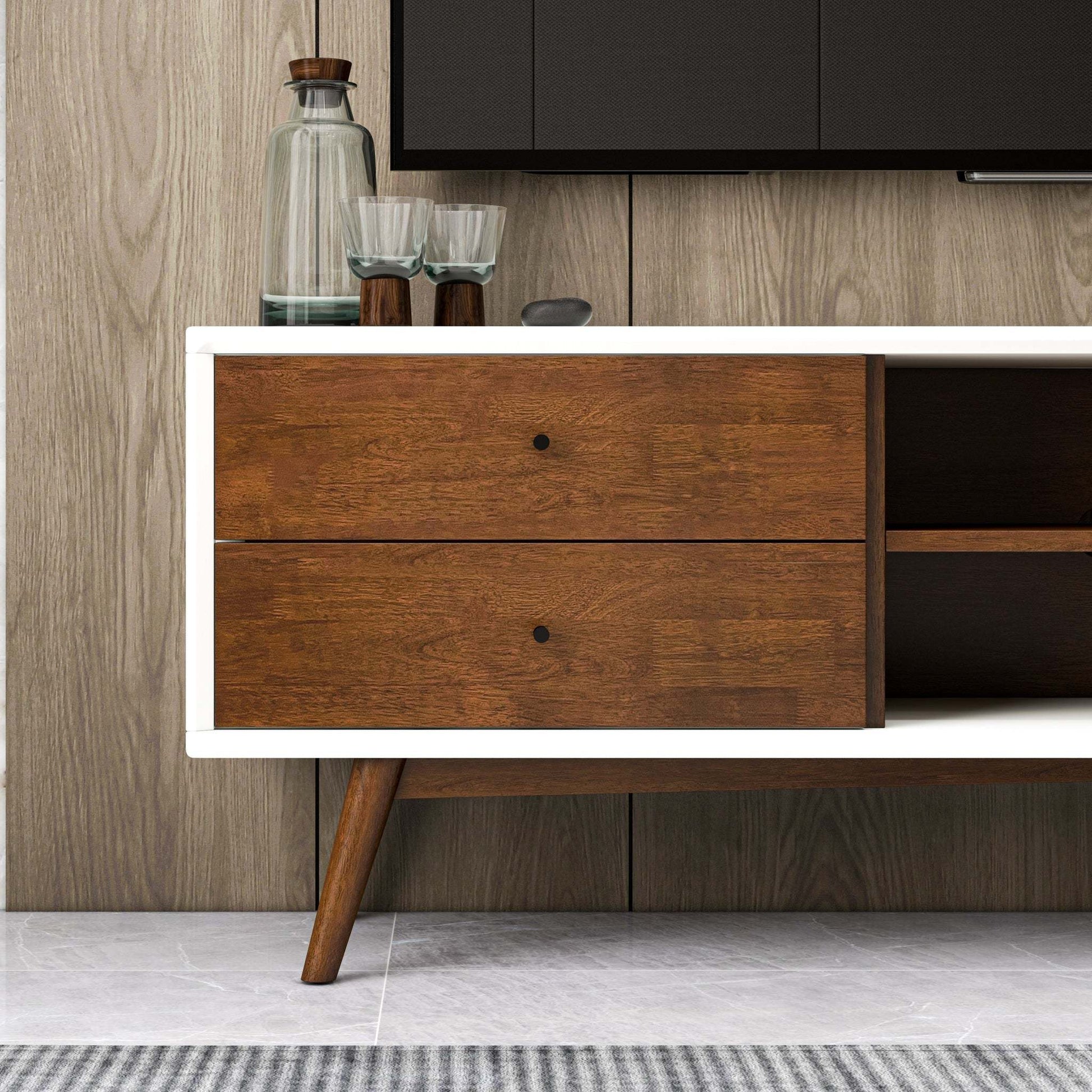 Mid-century modern wood sideboard with glassware on top in a stylish living room