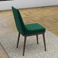 Modern green upholstered dining chair with wood legs on a textured rug, parquet floor