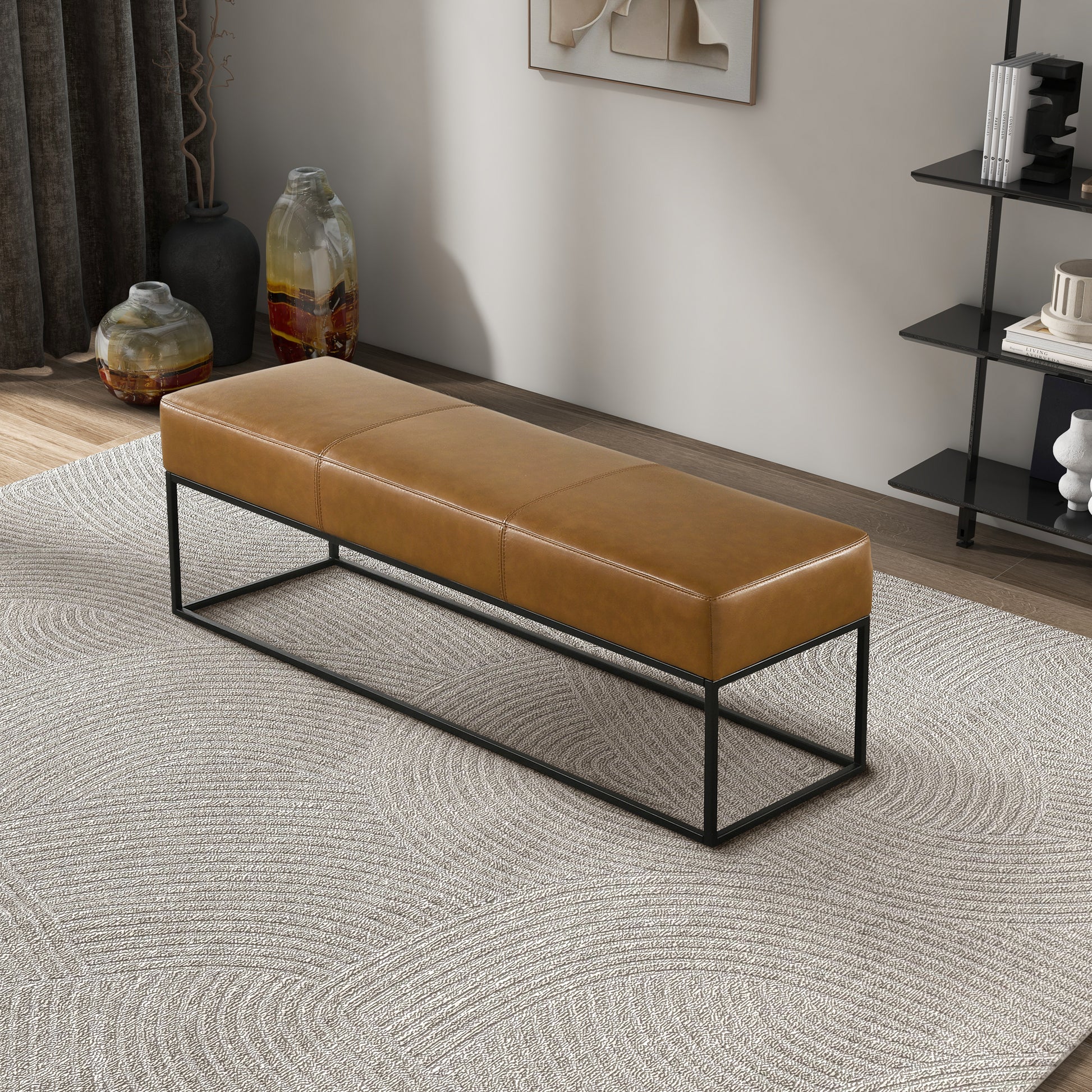 Modern tan leather bench with black metal frame on textured rug, FredCo International furniture