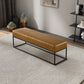 Modern tan leather bench with black metal frame on textured rug, FredCo International furniture