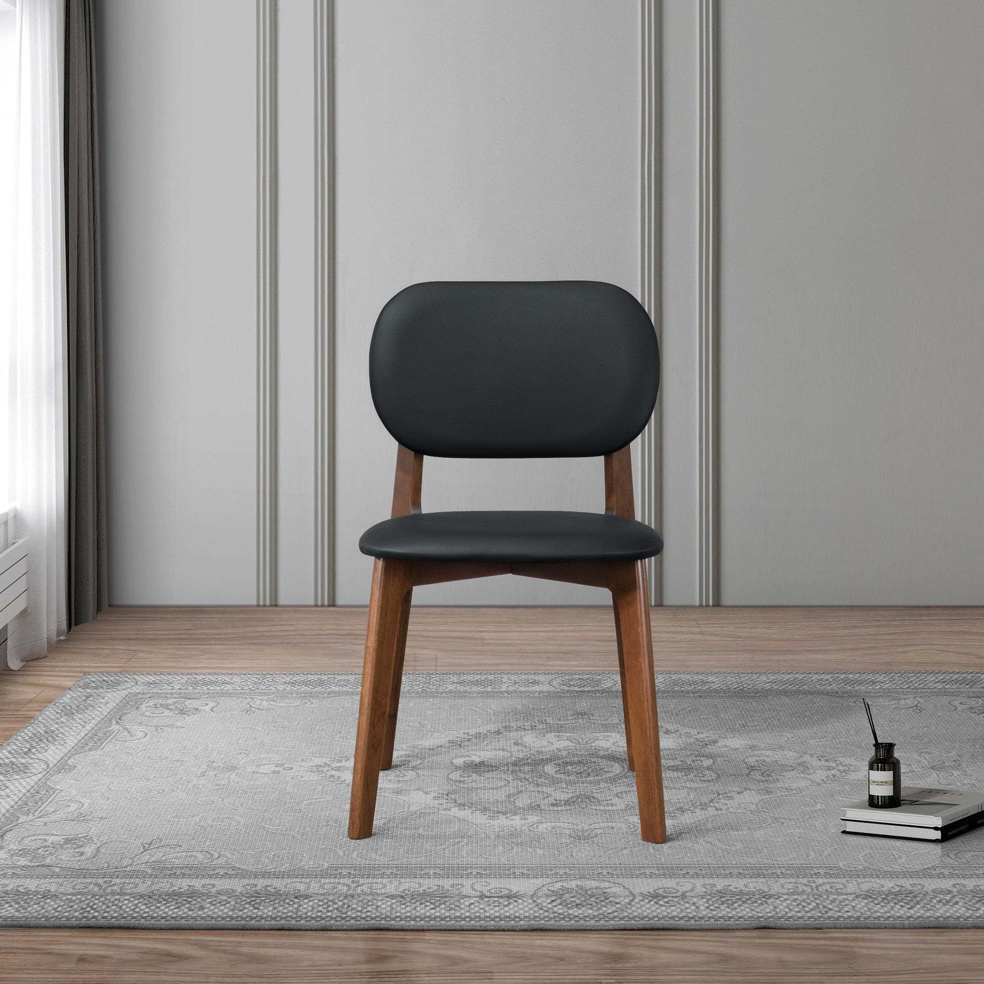 Modern black and wood accent chair on gray rug in stylish living room, FredCo International furniture