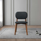Modern black and wood accent chair on gray rug in stylish living room, FredCo International furniture
