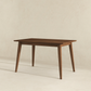Modern wooden dining table with angled legs on light background, FredCo International furniture