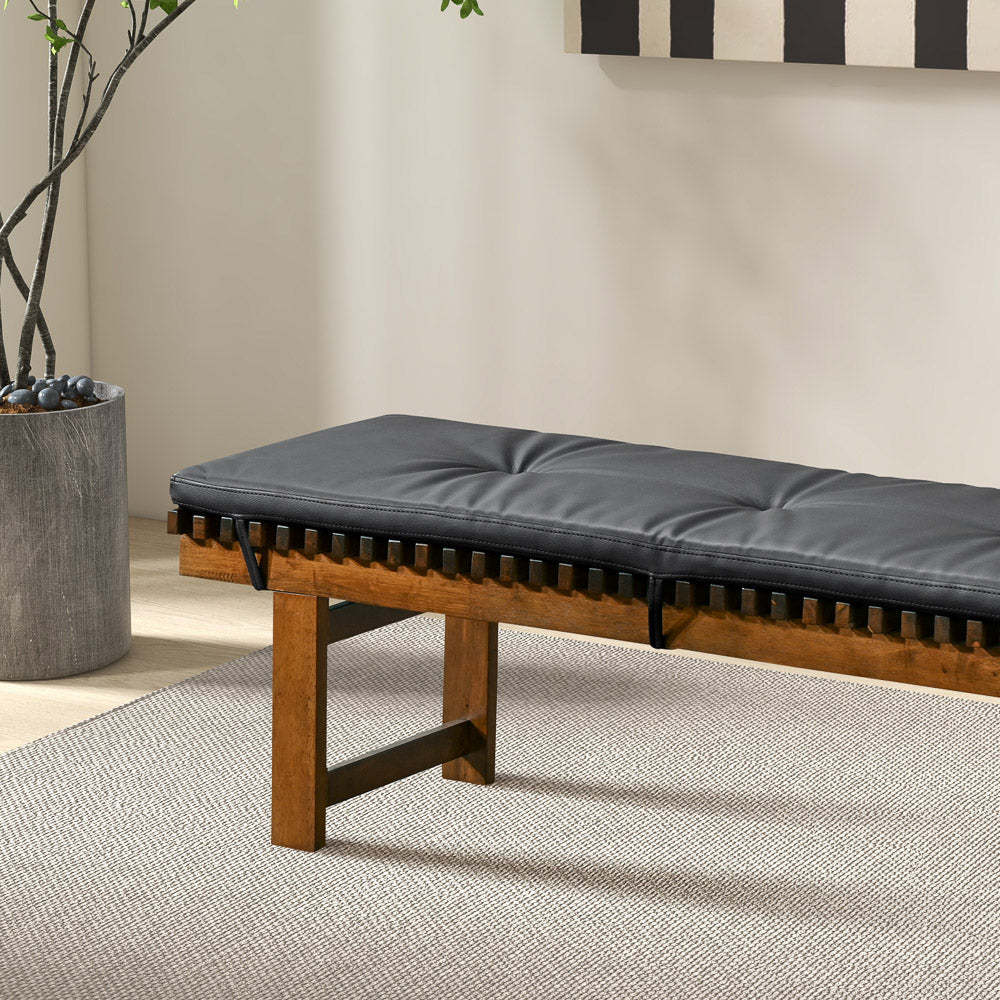 Modern wooden bench with black cushion on light rug, indoor home furniture from FredCo International