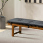 Modern wooden bench with black cushion on light rug, indoor home furniture from FredCo International