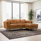 Modern tan leather sectional sofa in bright living room with large windows and geometric rug