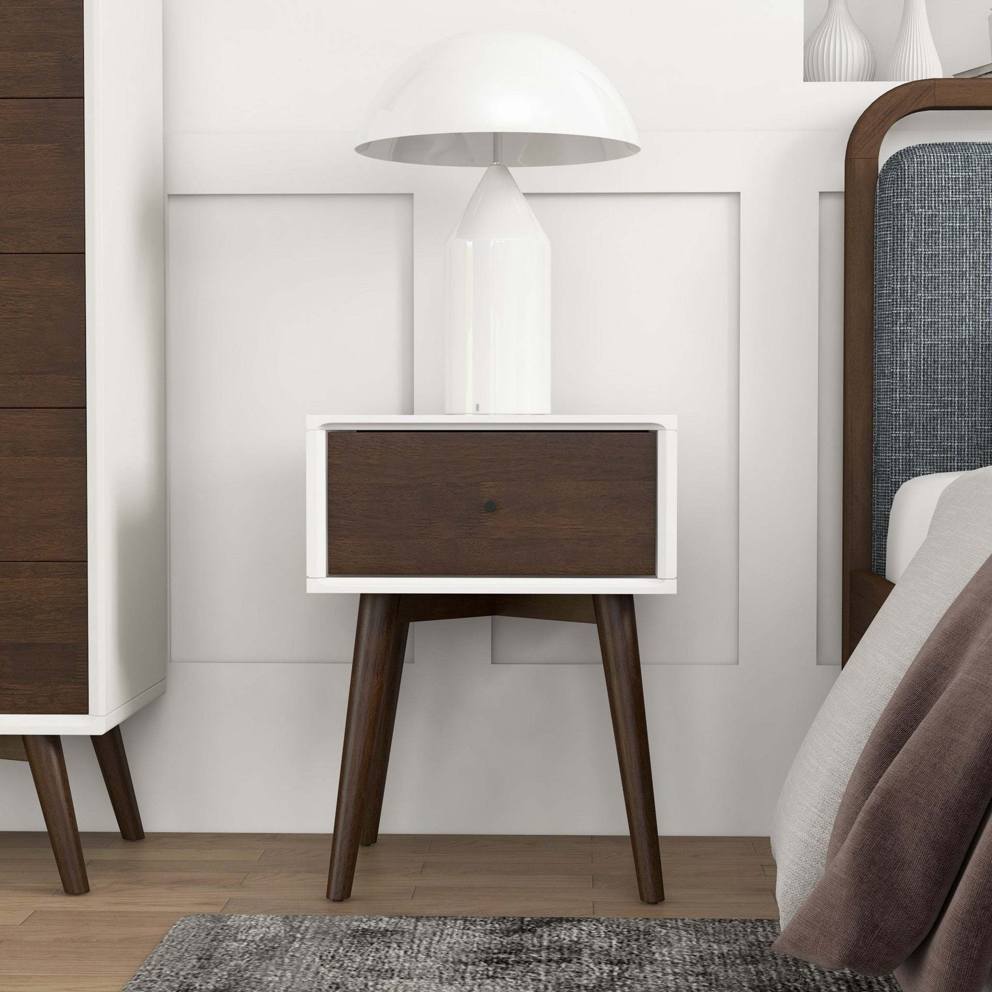 Modern bedroom with mid-century nightstand, white lamp, and wood furniture from FredCo International