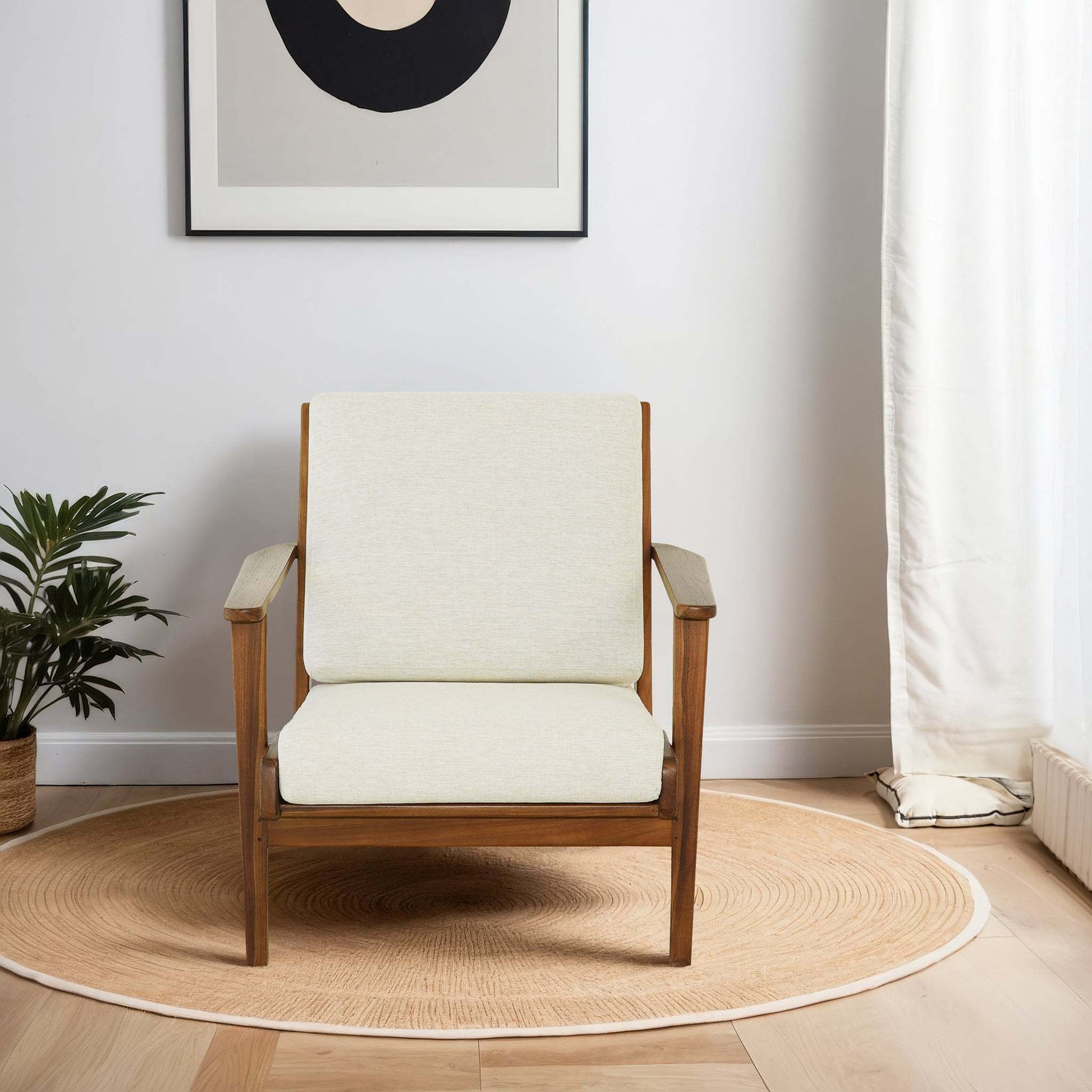 Modern wooden armchair with cream cushions on round rug in bright living room, FredCo International furniture