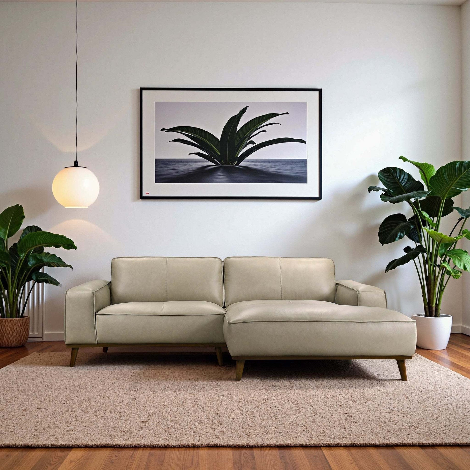 Modern beige sectional sofa in living room with houseplants, framed artwork, and pendant light