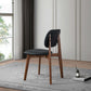 Modern black and wood dining chair on rug in bright living room, FredCo International furniture