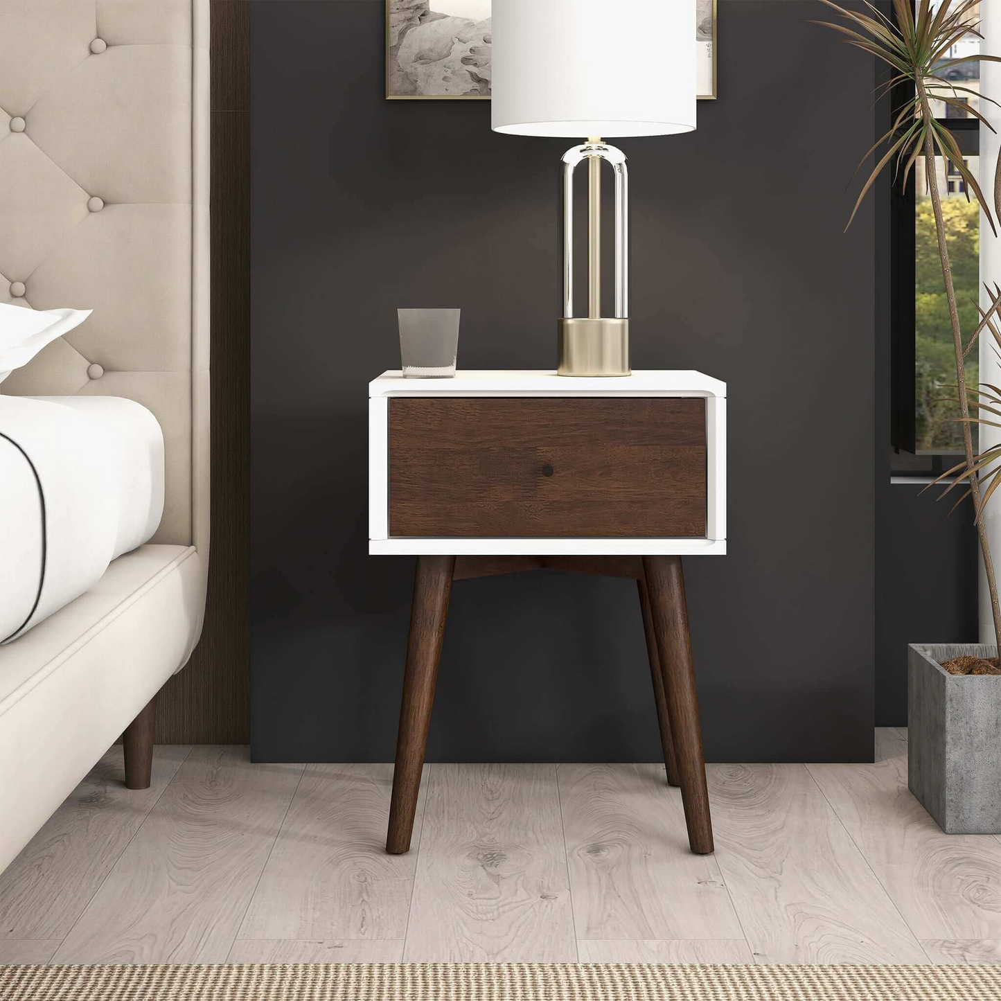 Modern wood nightstand with lamp and glass, next to bed in stylish bedroom setting