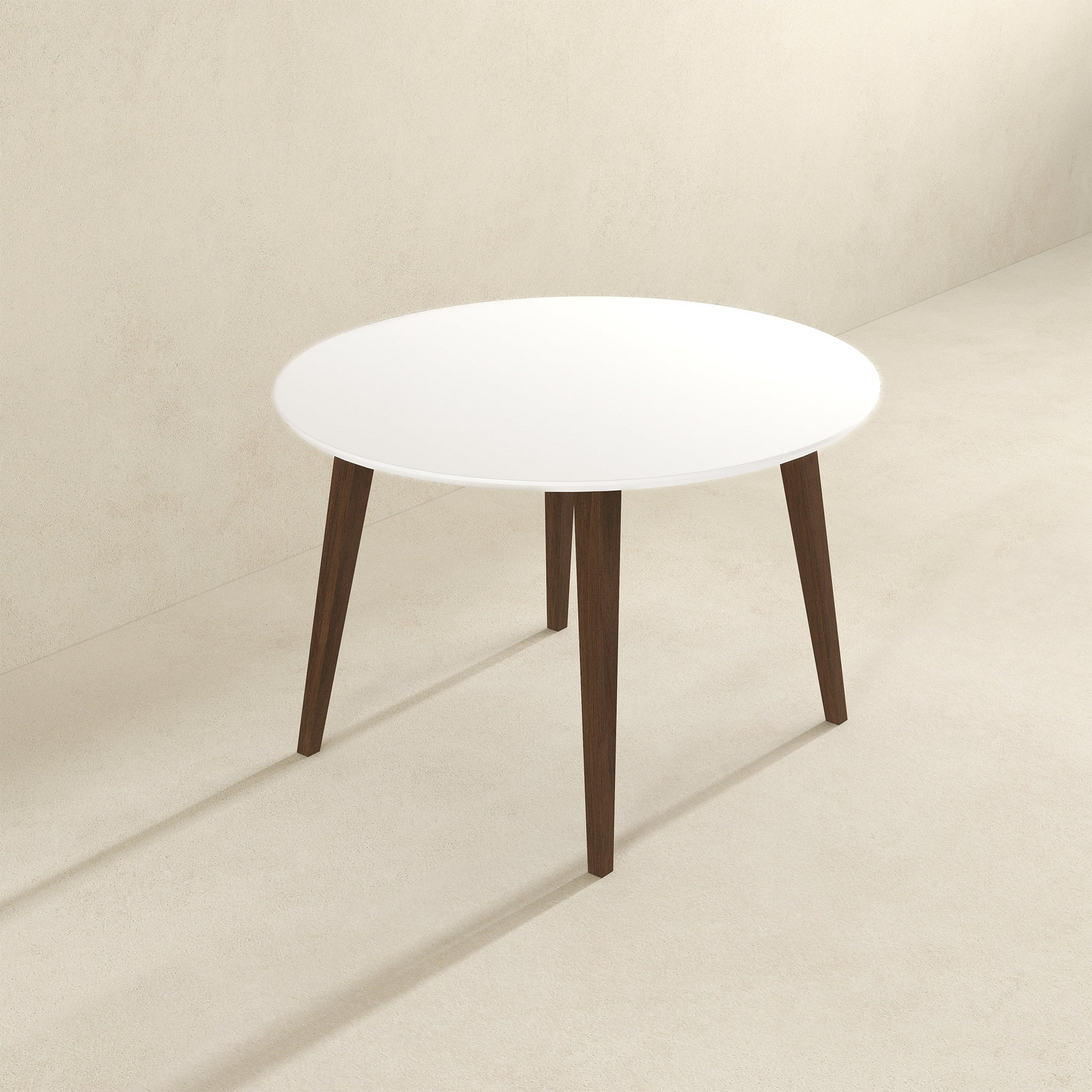 Modern round white dining table with wooden legs in minimalist room at FredCo International